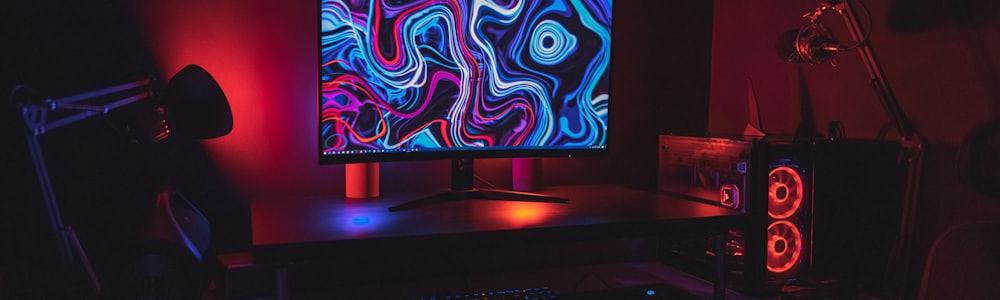 Operations desk monitors glowing in a dark office